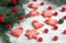 Gingerbread bells, stars, garland of felted beads and fir branches on a light background Christmas or New Year`s card.