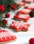 Gingerbread bells, stars, garland of felted beads and fir branches on a light background Christmas or New Year`s card.