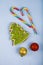 Gingerbread and candy canes on a blue wooden background. Christmas sweets and decorations