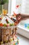 A gingerbread carousel and some Christmas decoration elements on a white wooden surface