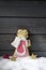 Gingerbread christmas angel star shaped decorations on heap of snow against wooden background