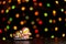 Gingerbread cookie of little postman  Santa over defocused colored lights of garland. Traditional Christmas food. Christmas and