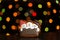 Gingerbread cookie of three snowman`s portrait over defocused colored lights of garland. Traditional Christmas food. Christmas an