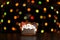 Gingerbread cookie of three snowman`s portrait over defocused colored lights of garland. Traditional Christmas food. Christmas an