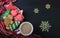 Gingerbread cookies in a bowl, cocoa in a cup and snowflakes on a black top