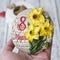 Gingerbread cookies casket with decor on 8 March holiday - yellow daffodils, the inscription in Russian 8 March. Female hand