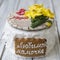 Gingerbread cookies casket with decor on 8 March holiday - yellow daffodils, red hearts cookies, butterflies, the inscription in