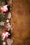 Gingerbread cookies, gift boxes, stars and snowflakes and spruce tree on wooden and paper background