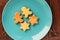 Gingerbread cookies man and star shape in turquoise plate on woo