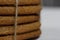 Gingerbread cookies tied with twine. On boards painted white. Close-up shot
