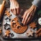 Gingerbread dough with metal cutters in different shapes for christmas cookies and wooden rolling pin, anise, ginger, cinnamon,