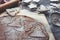 Gingerbread dough, rolled out with different Christmas shapes cut into it and sprinkled with powdered sugar