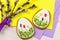 Gingerbread Easter eggs along with a willow twig on yellow and p