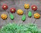 Gingerbread flowers with paper grass on rustic wooden background