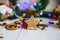 Gingerbread in the form of stars, red Christmas balls, dried lemons, cinnamon and green garland and lights