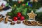 Gingerbread in the form of stars, red Christmas balls, dried lemons, cinnamon and green garland and lights