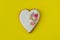 Gingerbread heart on yellow background. Top view. Ginger biscuit