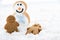 Gingerbread kids play with snowman on snow