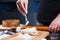 Gingerbread making. Woman sprinkling flour on gingerbread dough