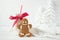 Gingerbread man and bottle of milk with straw on a white wooden background with Christmas trees