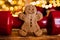 Gingerbread man cookie, red gym dumbbell and Christmas tree lights bokeh.