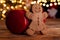 Gingerbread man cookie, red gym dumbbell and Christmas tree lights bokeh.