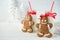 Gingerbread men and bottles of milk with straw on a white wooden background with Christmas trees decoration