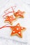 Gingerbread star cookies on white wood and snow background