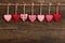 Gingham Love Valentine\'s hearts hanging on wooden texture backgr