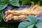 Ginseng root on the black plate with green nature background