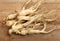 Ginseng root is placed on the wooden floor; Herbal Health Care.