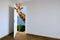 Giraffe entering a door. Animal watching from a wall. Child\'s imagination or a dream