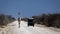 Giraffe meets Landrover on African gravel road