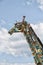 Giraffe sculpture in front of a cloudy sky