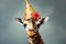 Giraffe wearing a birthday hat on gray background