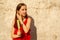 A girl 10 or 11 years old on a hot sultry day in a red dress. Summer teenager girl with ice cream