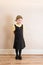 Girl (4) in school uniform pinafore