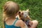 Girl 6 years old on the grass playing with Yorkshire Terrier