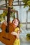 Girl, 6 years old.Her hair is loose. Yellow dress, Mimosa, beautiful interior. Laughing and holding a guitar. Music