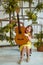 Girl, 6 years old.Her hair is loose. Yellow dress, Mimosa, beautiful interior. Laughing and holding a guitar. Music