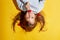 Girl 6 years old on a yellow background. Blue eyes and long hair. Holding a flower in his hands. Tenderness and a happy