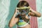 Girl (7-9) Adjusting Goggles in swimming pool portrait.