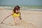 Girl 9 years old at sea. The portrait of the young girl about 9-12 years old. Teenager summer vacation sand. Sunny day