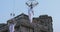 Girl acrobat in white dress in the air above the street in a big chandelier on the rope