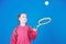 Girl adorable child play tennis. Practicing tennis skills and having fun. Athlete kid tennis racket on blue background