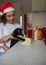 Girl and adorable pet cat at home with traditional panettone bread