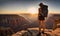 Girl in adventure attire stands at cliff edge, overlooking vast canyon