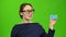 Girl advertises a card and shows a thumbs up. Green screen