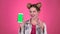 Girl advertises the phone. Pink background. Slow motion