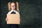 Girl Advertising Poster in School Classroom, Pupil Child in Glasses Hold Blank Board Advertisement